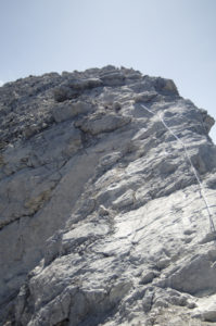 The final section of cable leading to the summit over an exposed slab section