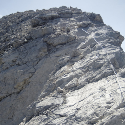 The final section of cable leading to the summit over an exposed slab section