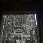 Another Lokesvara seen through a doorway on the upper level of the Bayon Temple Another Lokesvara seen through a doorway on the upper level of the Bayon Temple