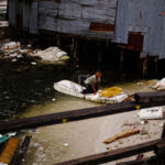 Boy on the rubbish Raft Boy on the rubbish Raft
