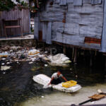 Boy on the rubbish Raft Boy on the rubbish Raft
