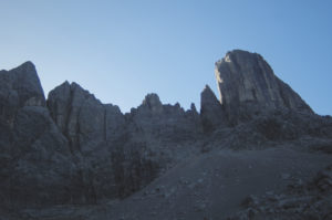 steep scree slope with Civettas towers above