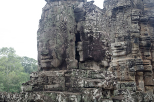 2 towers set at different heights each adorned by the Lokesvara faces